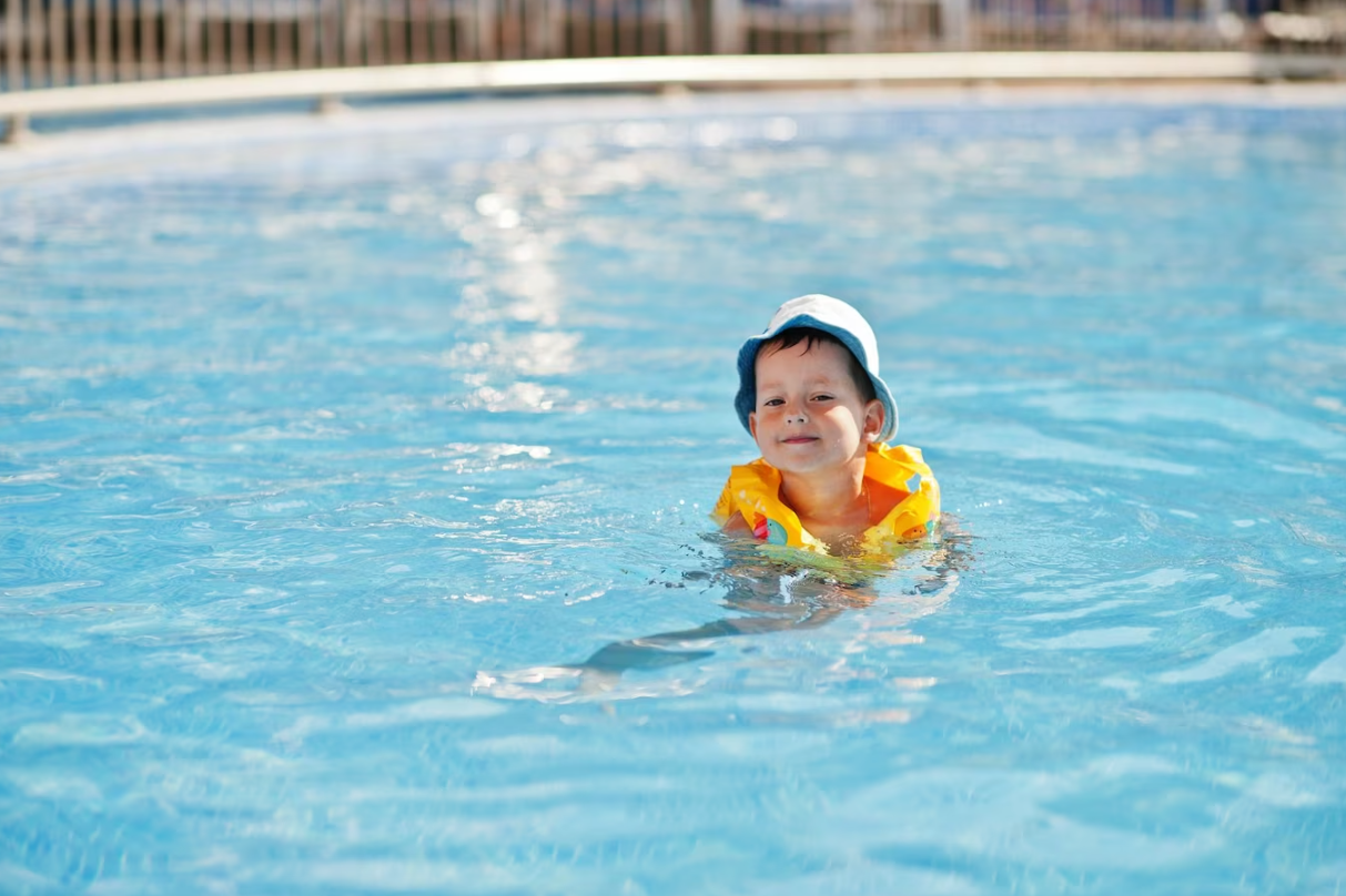 kids swim in swimming pool & enjoy