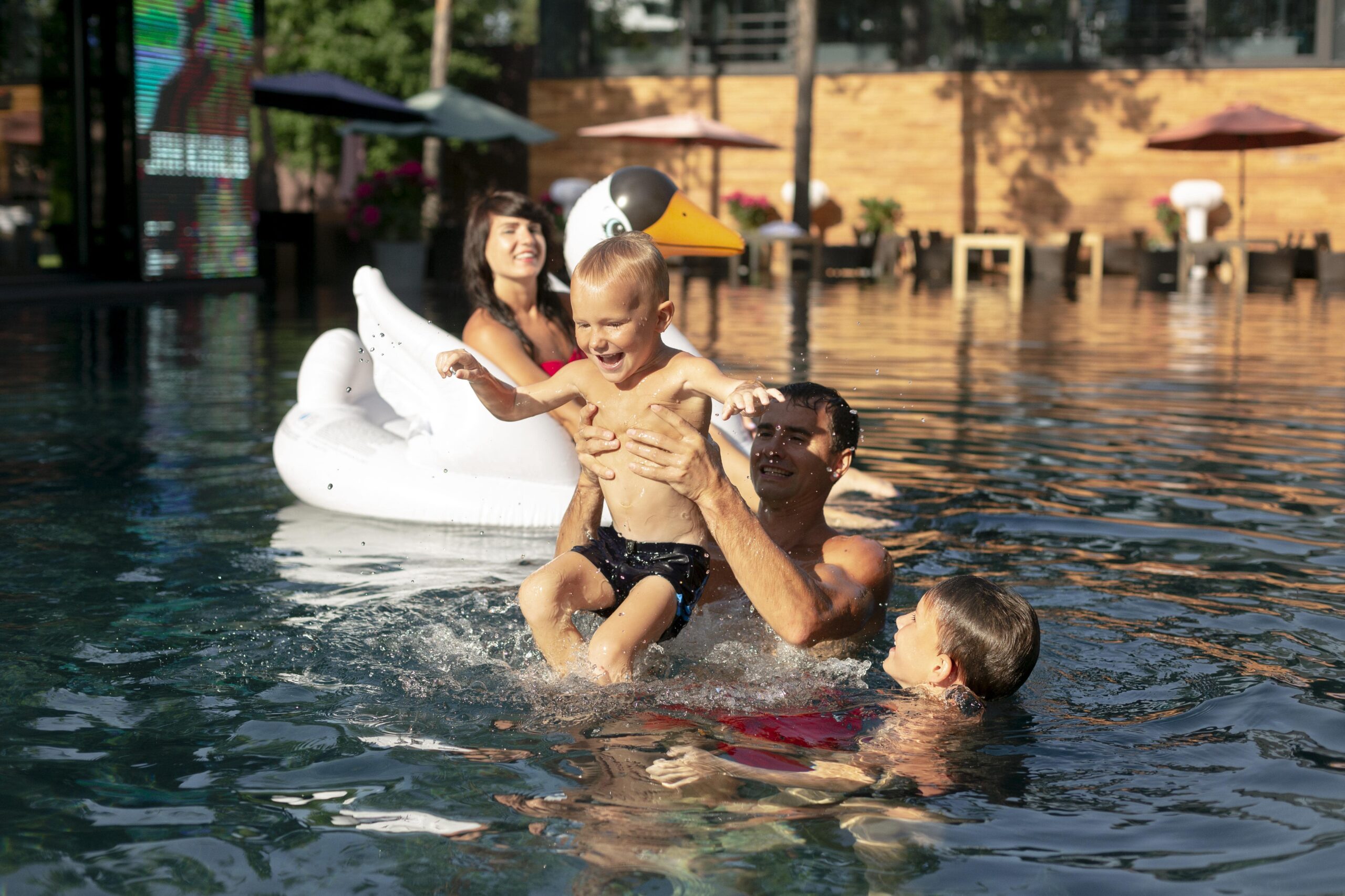 family four enjoying in swimming pool